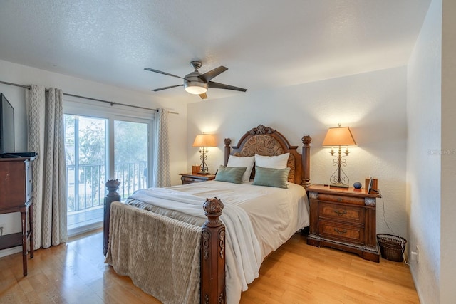 bedroom featuring ceiling fan, light hardwood / wood-style flooring, and access to outside