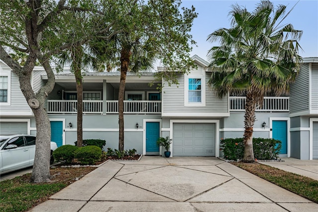 townhome / multi-family property with a balcony and a garage