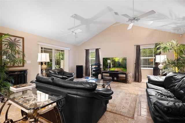 living room featuring ceiling fan, a healthy amount of sunlight, and vaulted ceiling