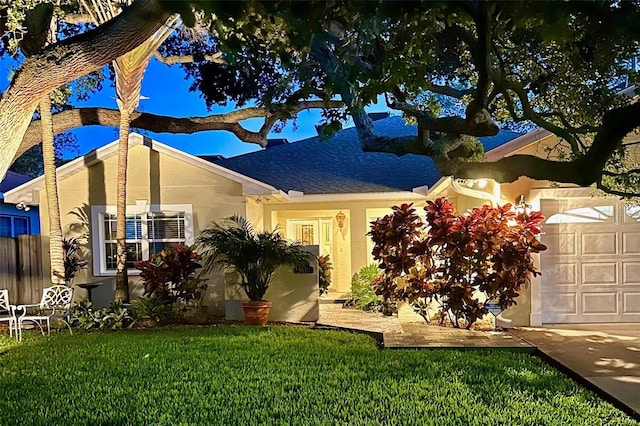 view of front of house with a front yard and a garage