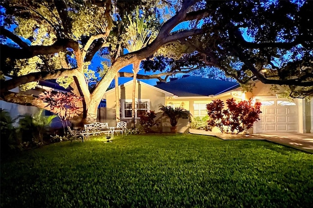 view of front of property featuring a garage and a front lawn