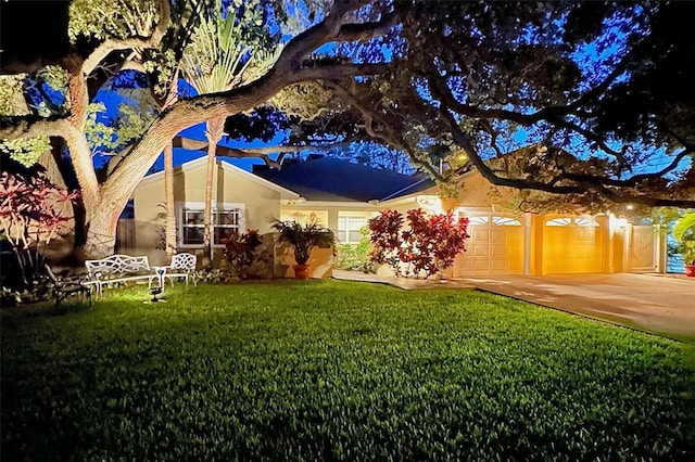 view of front of property with a front lawn and a garage