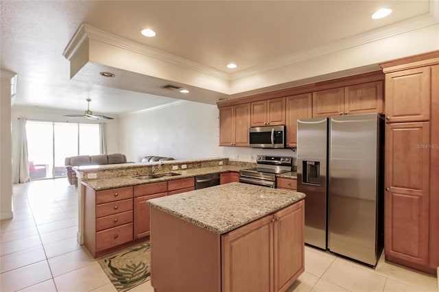 kitchen with appliances with stainless steel finishes, ceiling fan, sink, kitchen peninsula, and light stone countertops