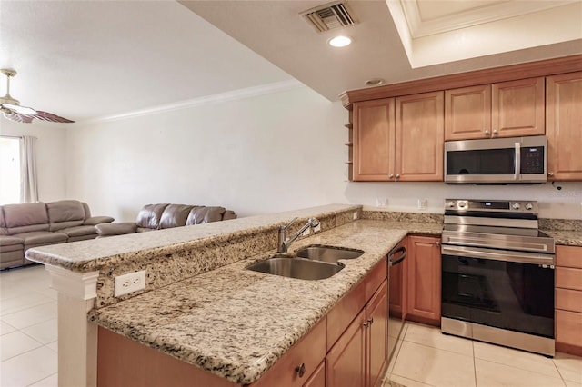 kitchen featuring light stone counters, ceiling fan, light tile floors, sink, and stainless steel appliances