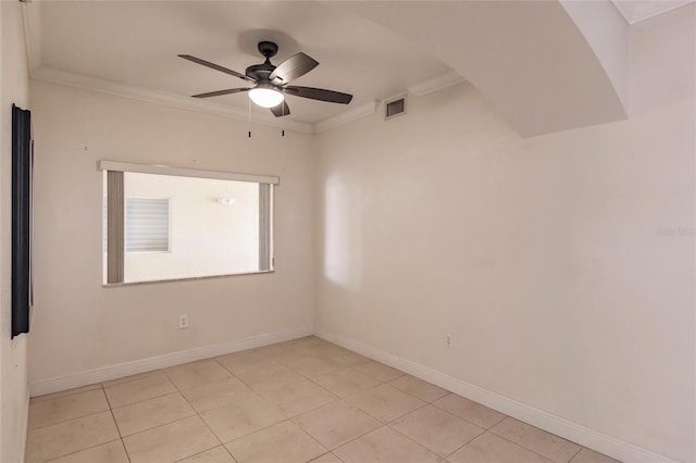 spare room featuring ornamental molding, ceiling fan, and light tile floors