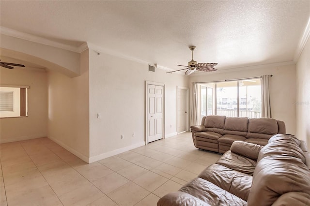 tiled living room featuring crown molding, ceiling fan, and a textured ceiling