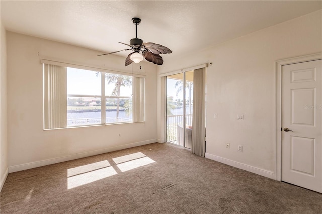 unfurnished bedroom with ceiling fan, carpet, and access to exterior