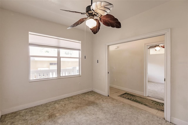 empty room with ceiling fan and light tile floors