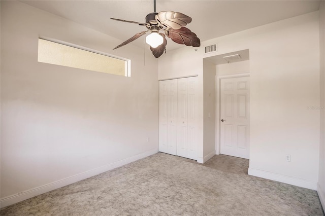 unfurnished bedroom featuring a closet, carpet floors, and ceiling fan