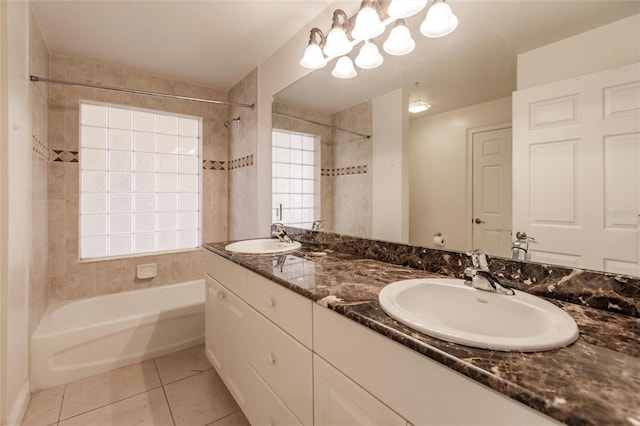 bathroom featuring tile flooring, tiled shower / bath, and double sink vanity