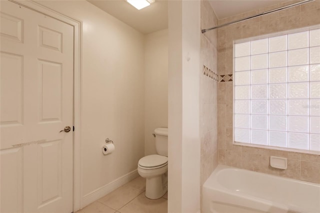 bathroom with tile floors, tiled shower / bath combo, and toilet