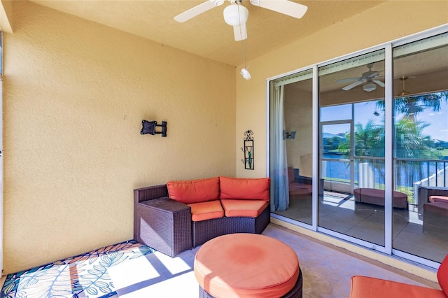 view of patio featuring ceiling fan and a balcony