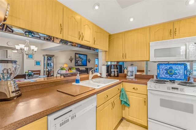 kitchen with white appliances, sink, light brown cabinetry, and a notable chandelier