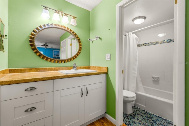 full bathroom featuring ceiling fan, shower / tub combo, a textured ceiling, toilet, and vanity