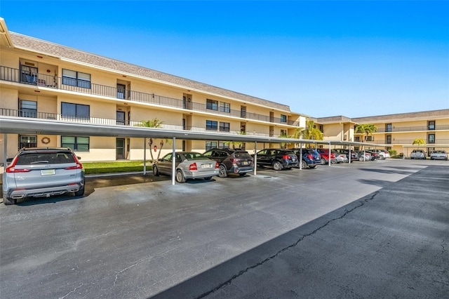 view of parking / parking lot featuring a carport