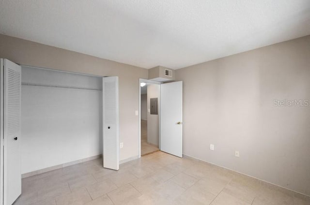 unfurnished bedroom with a closet and light tile floors