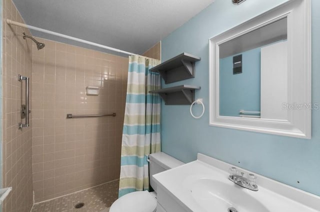 bathroom featuring vanity, curtained shower, and toilet