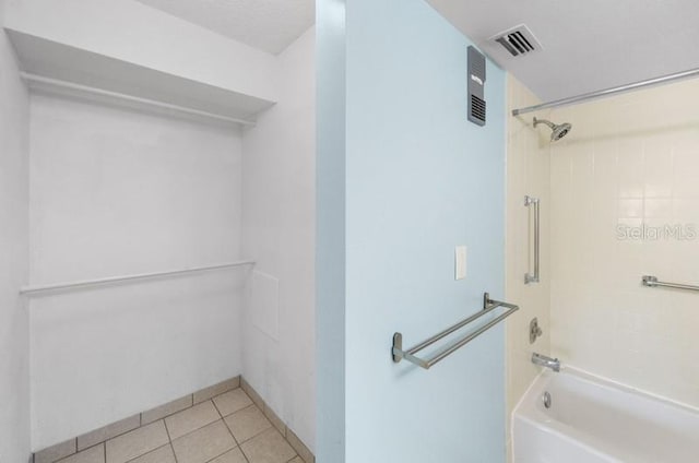 bathroom with bathing tub / shower combination and tile flooring