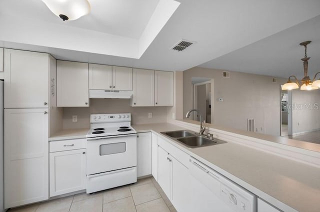 kitchen featuring white appliances, pendant lighting, sink, a chandelier, and light tile flooring