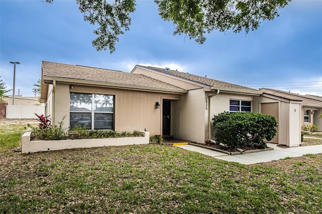 ranch-style home with a front lawn