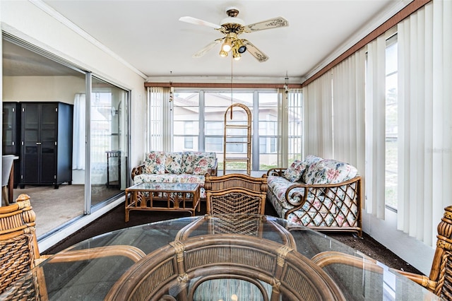 sunroom / solarium featuring ceiling fan