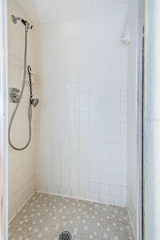 bathroom with a tile shower