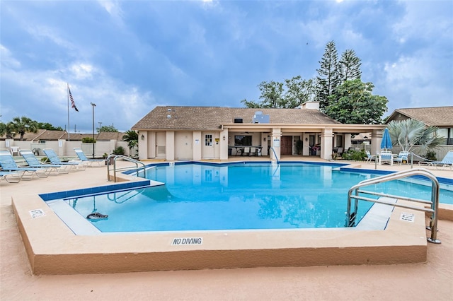 view of swimming pool with a patio area