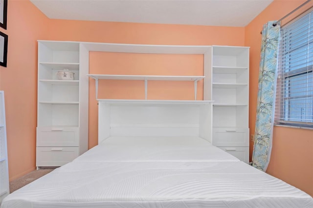 bedroom featuring light colored carpet