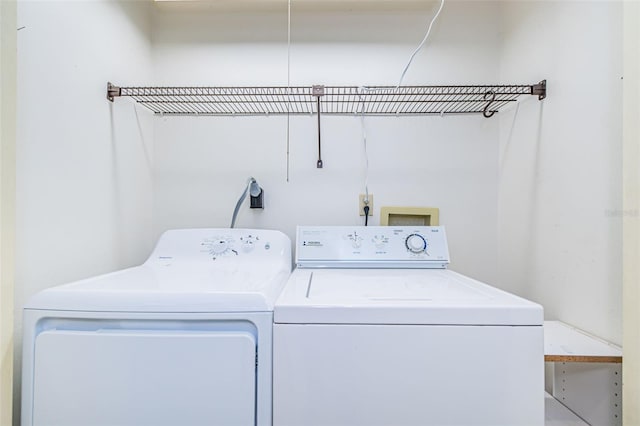 washroom with independent washer and dryer, hookup for an electric dryer, and hookup for a washing machine