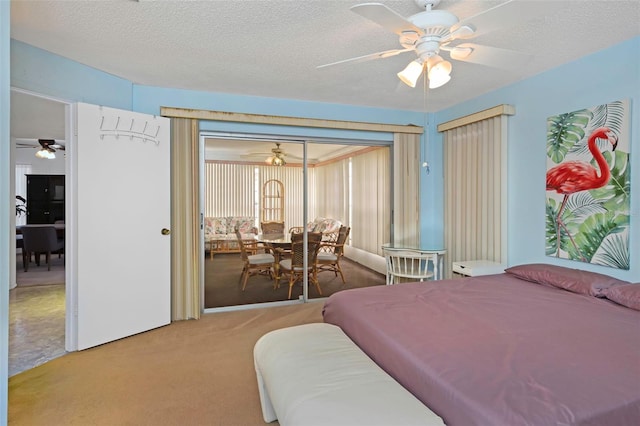 carpeted bedroom with ceiling fan and a textured ceiling