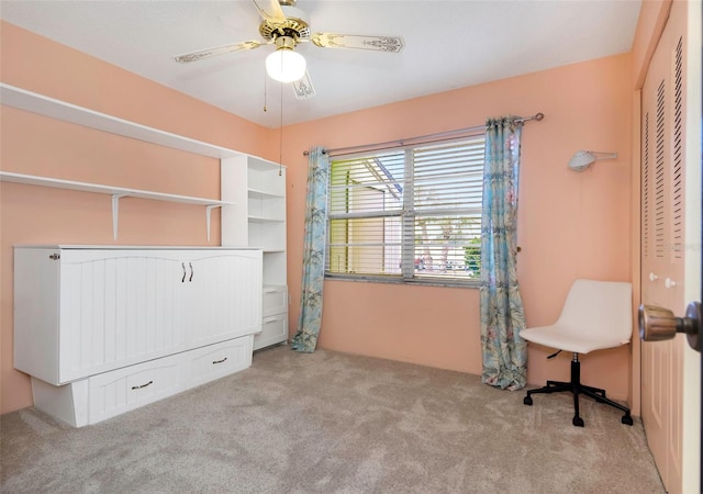 carpeted office featuring ceiling fan