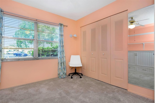 unfurnished bedroom featuring a closet, light colored carpet, and ceiling fan