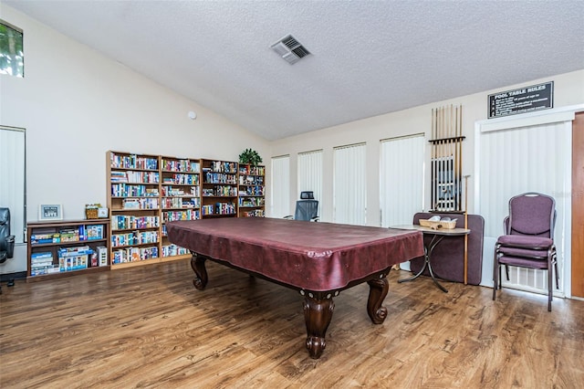 recreation room with high vaulted ceiling, a textured ceiling, billiards, and light hardwood / wood-style flooring