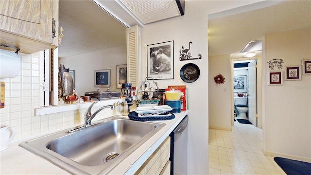 2205 Belleair Rd Unit A13, Clearwater, FL 33764 - kitchen with stainless steel dishwasher, sink, and a textured ceiling