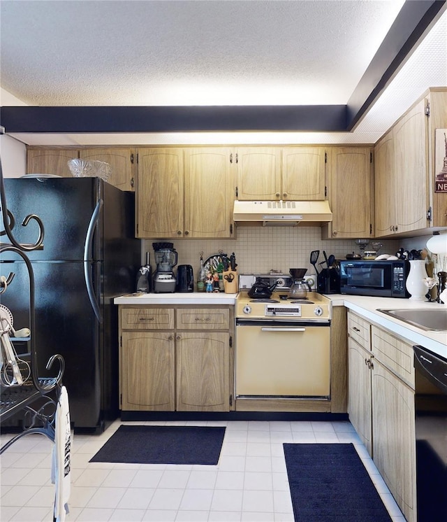 2205 Belleair Rd Unit A13, Clearwater, FL 33764 - kitchen with tasteful backsplash, sink, black appliances, and a textured ceiling