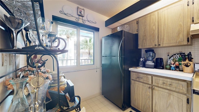 2205 Belleair Rd Unit A13, Clearwater, FL 33764 - kitchen featuring tasteful backsplash, black fridge, and a textured ceiling