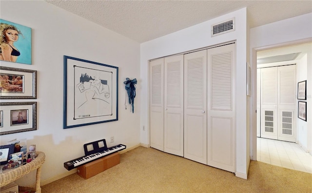 2205 Belleair Rd Unit A13, Clearwater, FL 33764 - carpeted bedroom with a textured ceiling and a closet