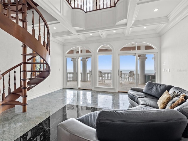 tiled living room with coffered ceiling, ornamental molding, and a towering ceiling