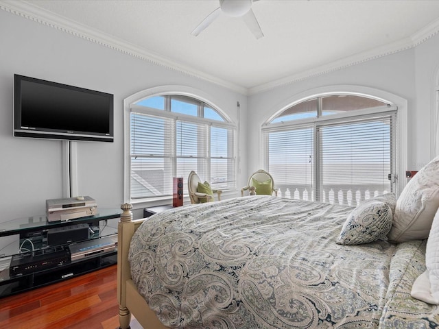 bedroom featuring ceiling fan, dark hardwood / wood-style flooring, and ornamental molding