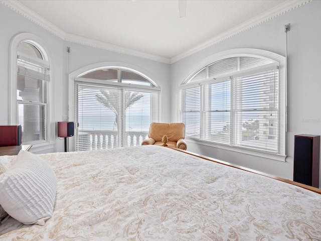 bedroom featuring multiple windows, crown molding, and ceiling fan