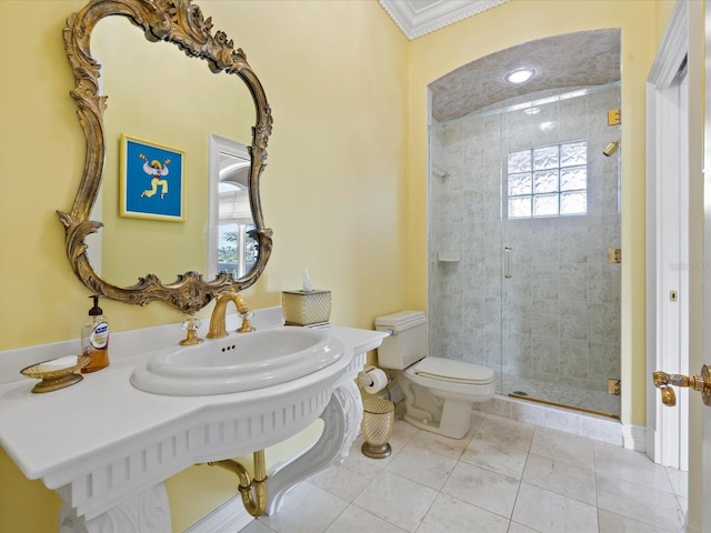 bathroom featuring toilet, ornamental molding, walk in shower, tile flooring, and sink