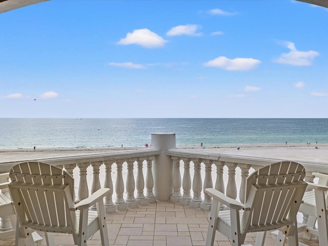 balcony featuring a water view and a view of the beach