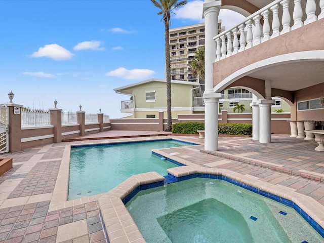 view of pool with an in ground hot tub