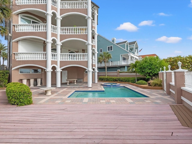 back of house featuring a balcony and a patio