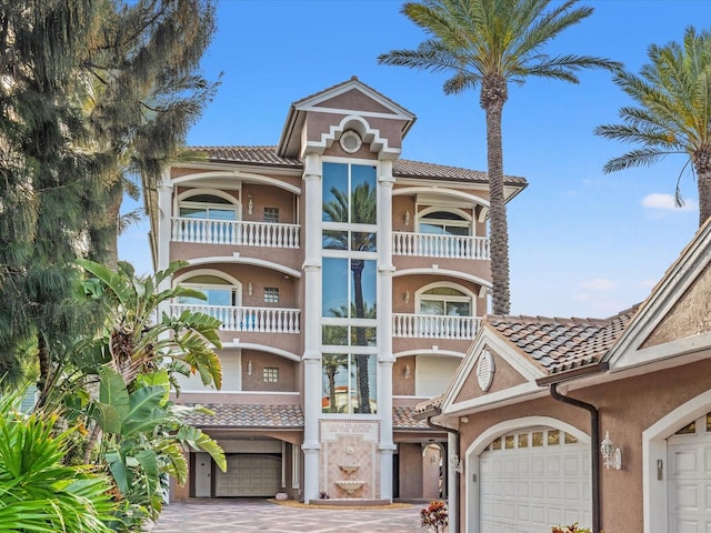 view of front of property with a balcony and a garage