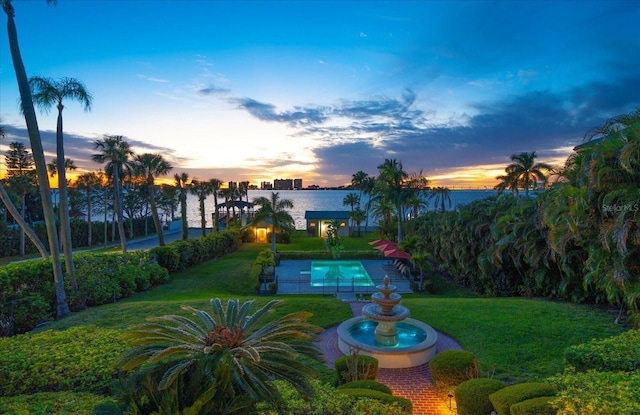 exterior space featuring a swimming pool and a water view