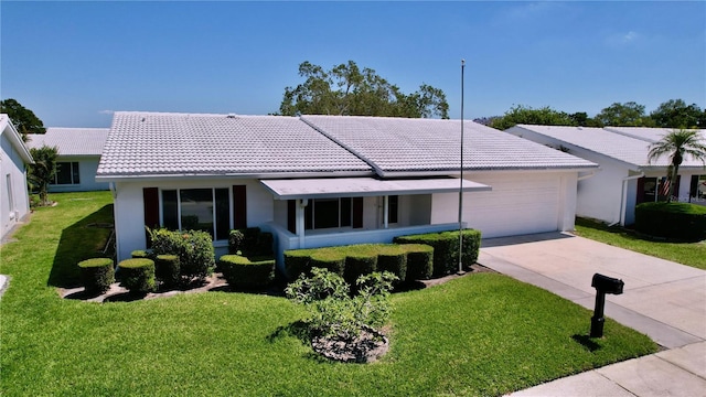 single story home featuring a garage and a front lawn