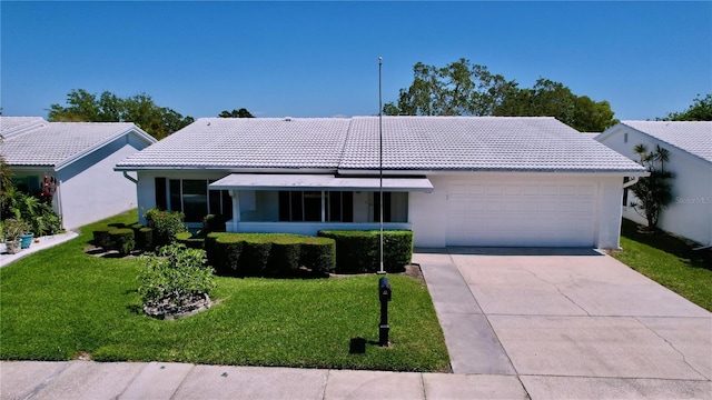 single story home featuring a garage and a front yard