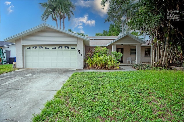 single story home with a garage and a front lawn