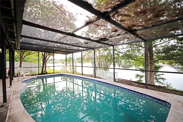 view of pool with a lanai, a patio area, and a water view